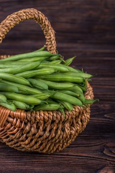 Fresh green beans on wooden table on rustic wooden background, selective focus
