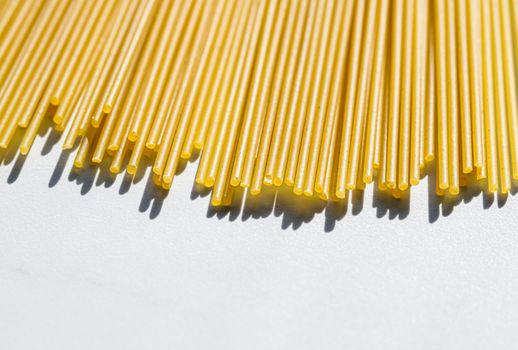 Uncooked whole grain spaghetti closeup, italian pasta as organic food ingredient, macro product and cook book recipes