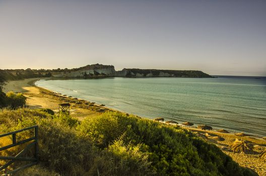 Panoramic view of the beach of Gerakas with its golden sand umbrellas and cliffs bathed by the Ionian sea