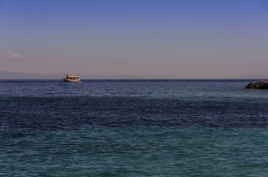 passenger ship at sunset navigating the Ionian sea near the shores of the island of zakynthos