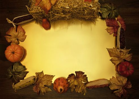 Flat lay frame formed by fall harvest items with gold center.