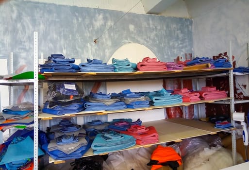 Colorful swatches of fabric, a sewing workpiece lying on the shelves.