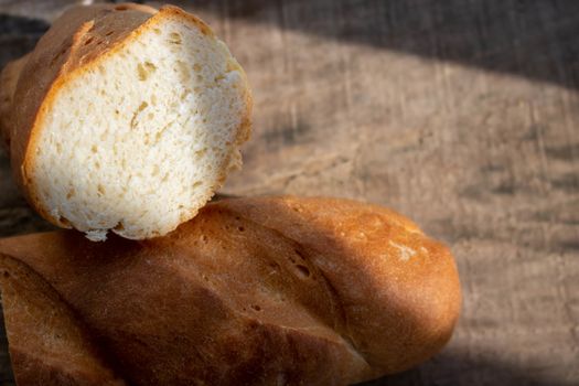 Fresh bread on a rough wooden table. Food background