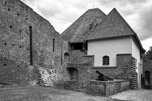 Ruins of walls of a medieval defensive castle in the city of Miedzyrzecz in Poland, black and white