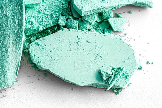 Mint eye shadow powder as makeup palette closeup isolated on white background, crushed cosmetics and beauty textures