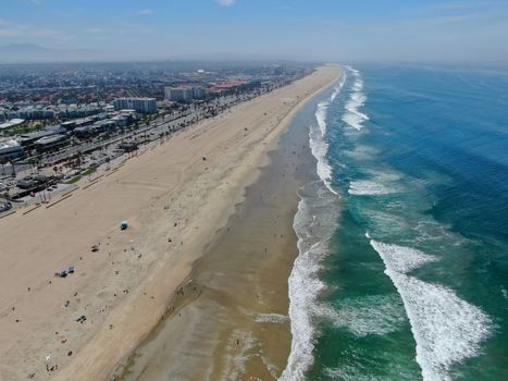 Aerial view of Huntington Beach and coastline during hot blue sunny summer day, Southeast of Los Angeles. California. destination for holiday and surfer