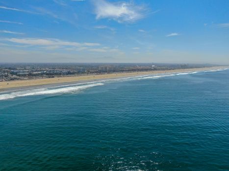 Aerial view of Huntington Beach and coastline during hot blue sunny summer day, Southeast of Los Angeles. California. destination for holiday and surfer