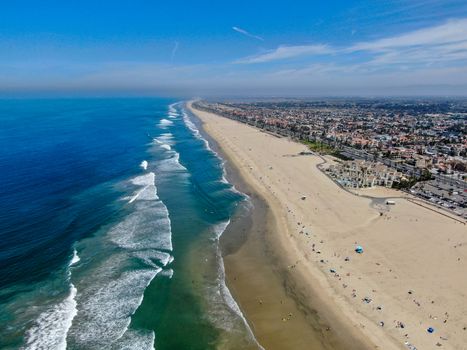 Aerial view of Huntington Beach and coastline during hot blue sunny summer day, Southeast of Los Angeles. California. destination for holiday and surfer