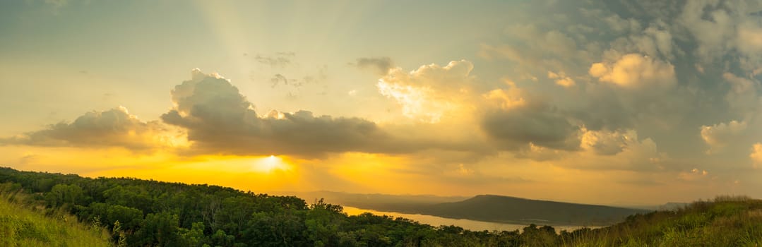 Panorama Sunset with ray light on clouds in a blue and orange sky in twilight time