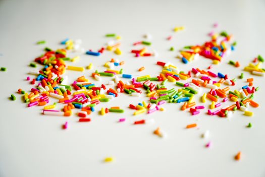 Selective focus colorful sugar sprinkle dots for decoration topping cake and ice cream on the table.