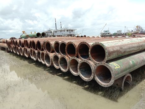 old Iron pipe stock near of river for sand collection