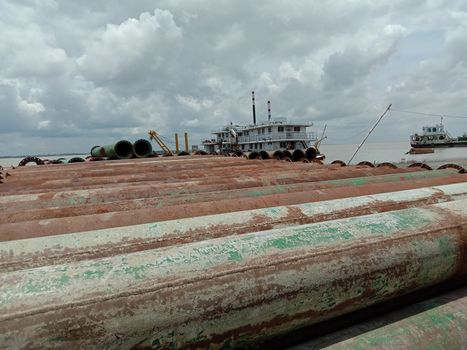 old Iron pipe stock near of river for sand collection