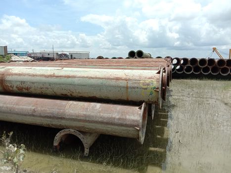 old Iron pipe stock near of river for sand collection