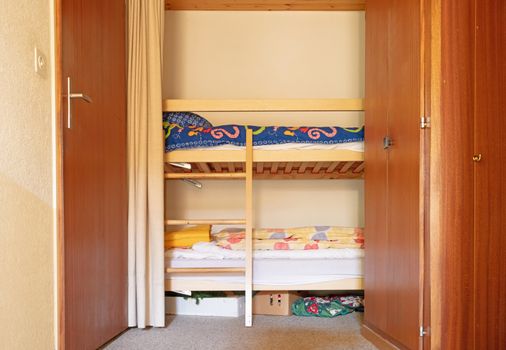 Bunk bed in the hallway of an old apartment, selective focus