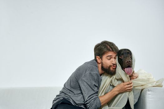 Happy man with dog and light fabric fun scarf friends pet. High quality photo