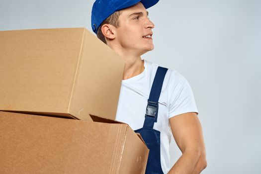 working man in uniform with boxes in his hands delivery loader lifestyle. High quality photo