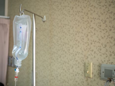 Saline jar hanging in a steel pole in the hospital. Health and medical equipment concept.