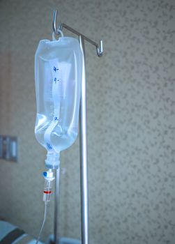 Saline jar hanging in a steel pole in the hospital. Health and medical equipment concept.