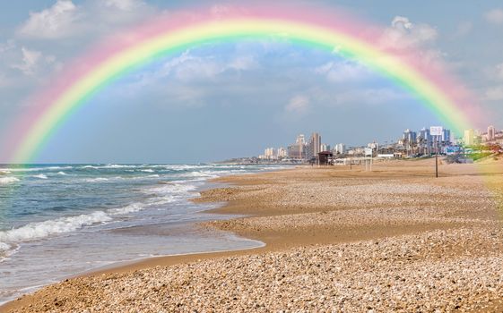 the haifa beach in israel with the city as background and a raw sea with waves at the coastline