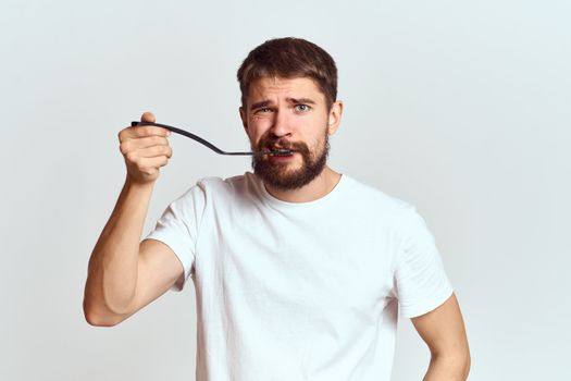 man with cooking shovel and white t-shirt close-up cropped view emotion gesturing with hand. High quality photo