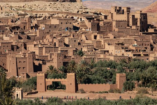 A high level view of the old Ait Ben Haddou ksar Morocco, ancient fortress that is a Unesco Heritage site. Beautiful late afternoon light with honey, gold coloured mud brick construction the kasbah, or fortified town dates from 11th cent. and is on the former caravan route from the Sahara and Marrakech. The location has been used for many famous movies. High quality photo