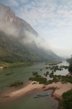 Nam Ou River, boats and landscape with mountains and riverside villages. High quality photo