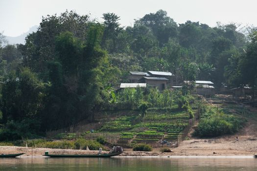 Nam Ou River, boats and landscape with mountains and riverside villages. High quality photo