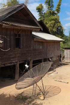 Ban Napia near Phonsavan Laos village houses where people make spoons from bombs leftover from Vietnam war and use empty bomb casings . High quality photo