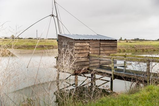 Carrelet de Peche, the emblematic fisherman's hut of the coastal landscapes of Vendee, Charente-Maritime, in the estuary of La Gironde, La Charente, La Loire or in the Marais Poitevin