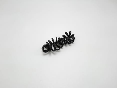 Black plastic spiral head band use to tie hair of a girl
