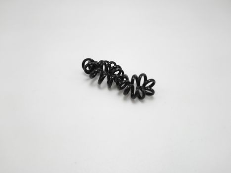 Black plastic spiral head band use to tie hair of a girl