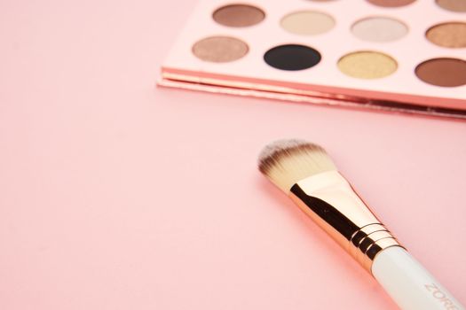 makeup brushes and eyeshadow professional cosmetics on pink background. High quality photo