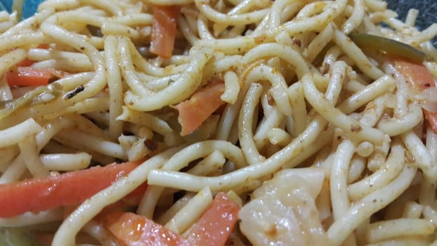 close up view of swirling noodles or spaghetti pasta in a bowl