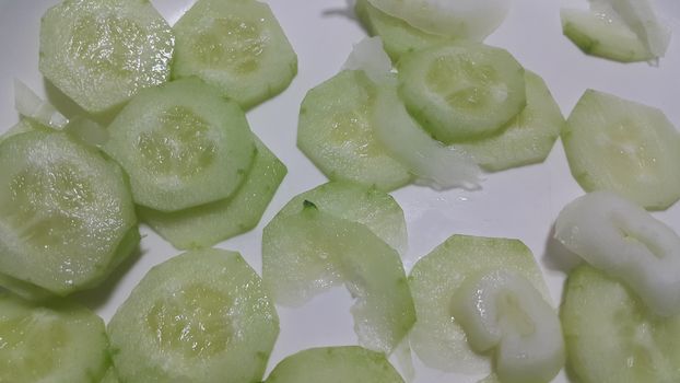 Closeup view of  fresh cucumber slices, juicy and tasty slices, A food background