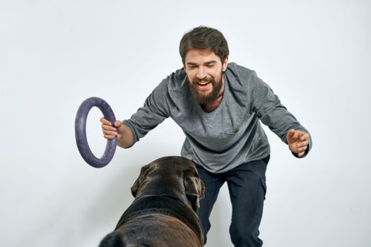 happy owner with pet black dog training model emotions. High quality photo