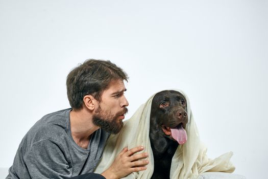 Happy man with dog and light fabric fun scarf friends pet. High quality photo