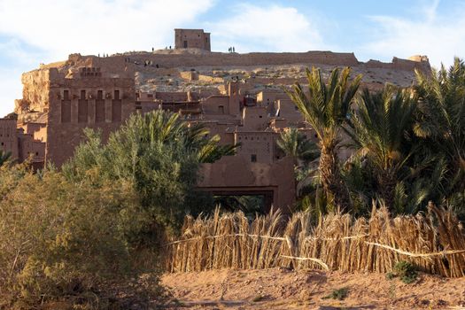 Ait Ben Haddou ksar Morocco, ancient fortress that is a Unesco Heritage site. Beautiful late afternoon light with honey, gold coloured mud brick construction the kasbah, or fortified town dates from 11th cent. and is on the former caravan route from the Sahara and Marrakech. The location has been used for many famous movies. High quality photo