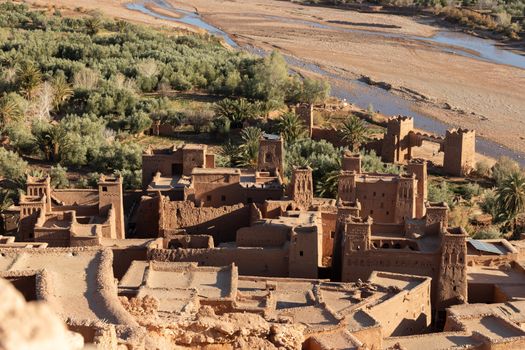 Ait Ben Haddou ksar Morocco, ancient fortress that is a Unesco Heritage site. Beautiful late afternoon light with honey, gold coloured mud brick construction the kasbah, or fortified town dates from 11th cent. and is on the former caravan route from the Sahara and Marrakech. The location has been used for many famous movies. High quality photo