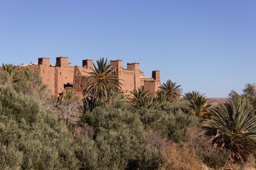 Ait Ben Haddou ksar Morocco, ancient fortress that is a Unesco Heritage site. Beautiful late afternoon light with honey, gold coloured mud brick construction the kasbah, or fortified town dates from 11th cent. and is on the former caravan route from the Sahara and Marrakech. The location has been used for many famous movies. High quality photo