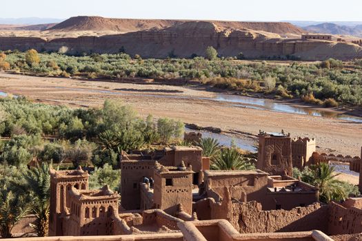 Ait Ben Haddou ksar Morocco, ancient fortress that is a Unesco Heritage site. Beautiful late afternoon light with honey, gold coloured mud brick construction the kasbah, or fortified town dates from 11th cent. and is on the former caravan route from the Sahara and Marrakech. The location has been used for many famous movies. High quality photo