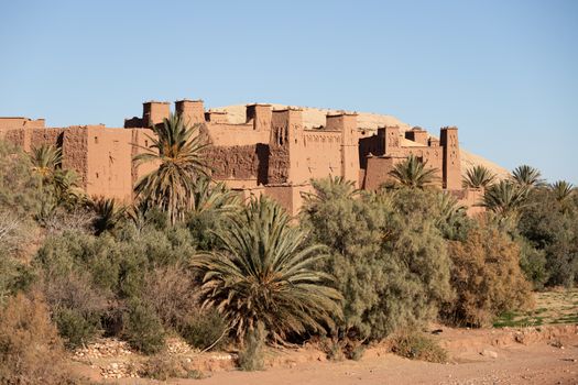 Ait Ben Haddou ksar Morocco, ancient fortress that is a Unesco Heritage site. Beautiful late afternoon light with honey, gold coloured mud brick construction the kasbah, or fortified town dates from 11th cent. and is on the former caravan route from the Sahara and Marrakech. The location has been used for many famous movies. High quality photo