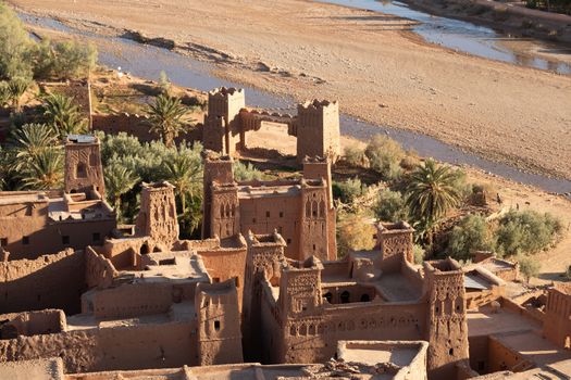 Ait Ben Haddou ksar Morocco, ancient fortress that is a Unesco Heritage site. Beautiful late afternoon light with honey, gold coloured mud brick construction the kasbah, or fortified town dates from 11th cent. and is on the former caravan route from the Sahara and Marrakech. The location has been used for many famous movies. High quality photo