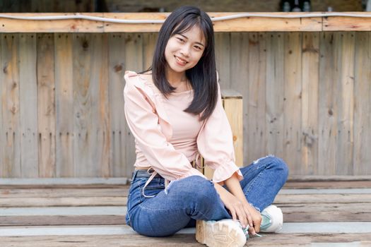 Portrait of asian happy woman smiling with wooden bridge, Selective focus