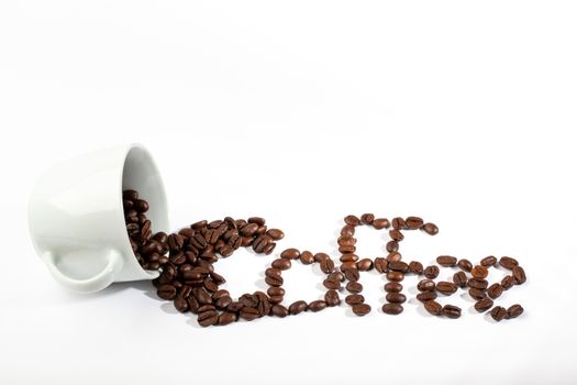 A White cup with coffee beans on white background