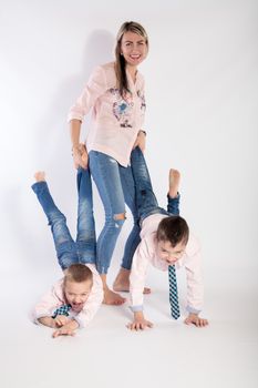 Mother with her kids is playing, in blue jeans