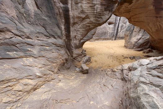 Desert view through Sand Dune Arch, Arches National Park, Utah.