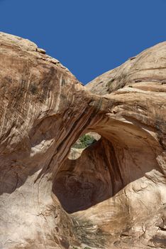 Desert view through the Bowtie Arch, Utah.
