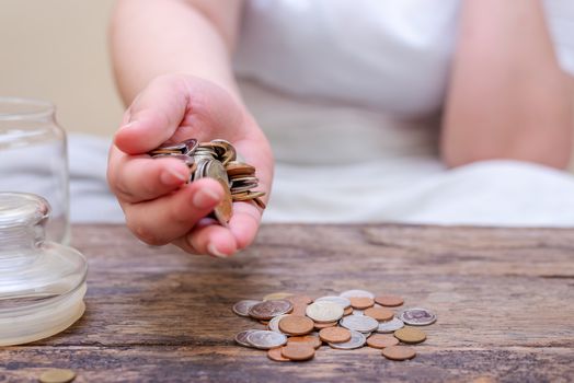 Save money and account banking for finance concept, Hand with coin on blurred background