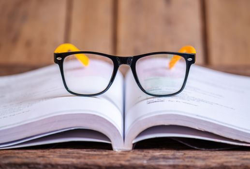 Read and knowledge concept, Glasses on the book blurred background, Selective focus