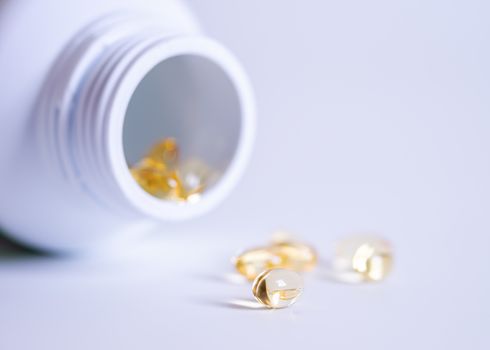 Pill spilling out of a bottle blurred background, Medicine capsule for health, Vitamin spilling out from bottle, Macro